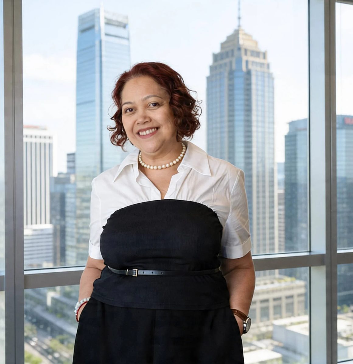 Tish Valles, President and CEO of ExcelCSI, before the Makati skyline