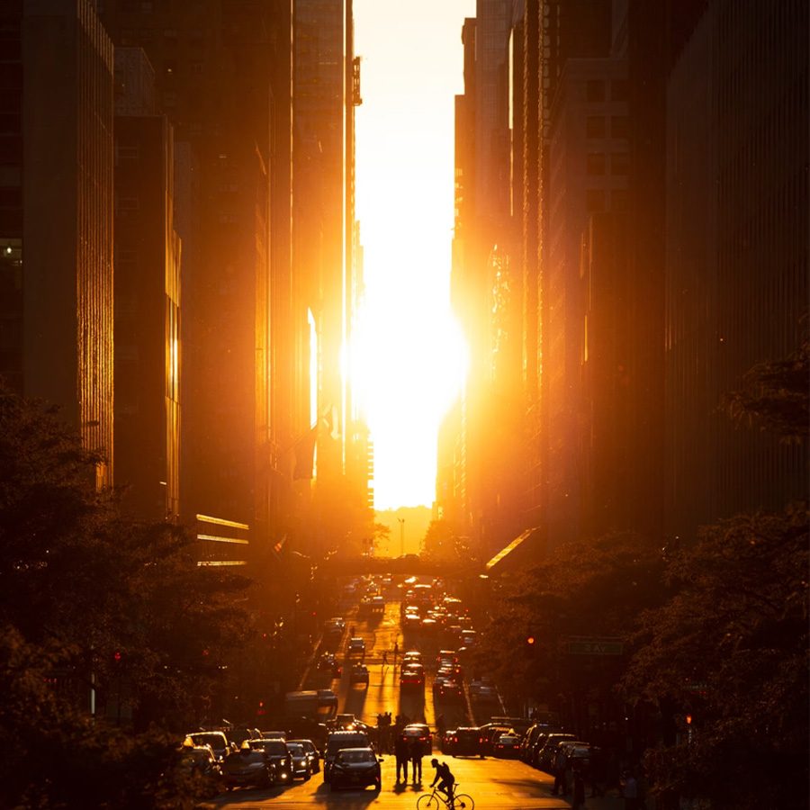 Sunset aligned down a Manhattan street between the towers