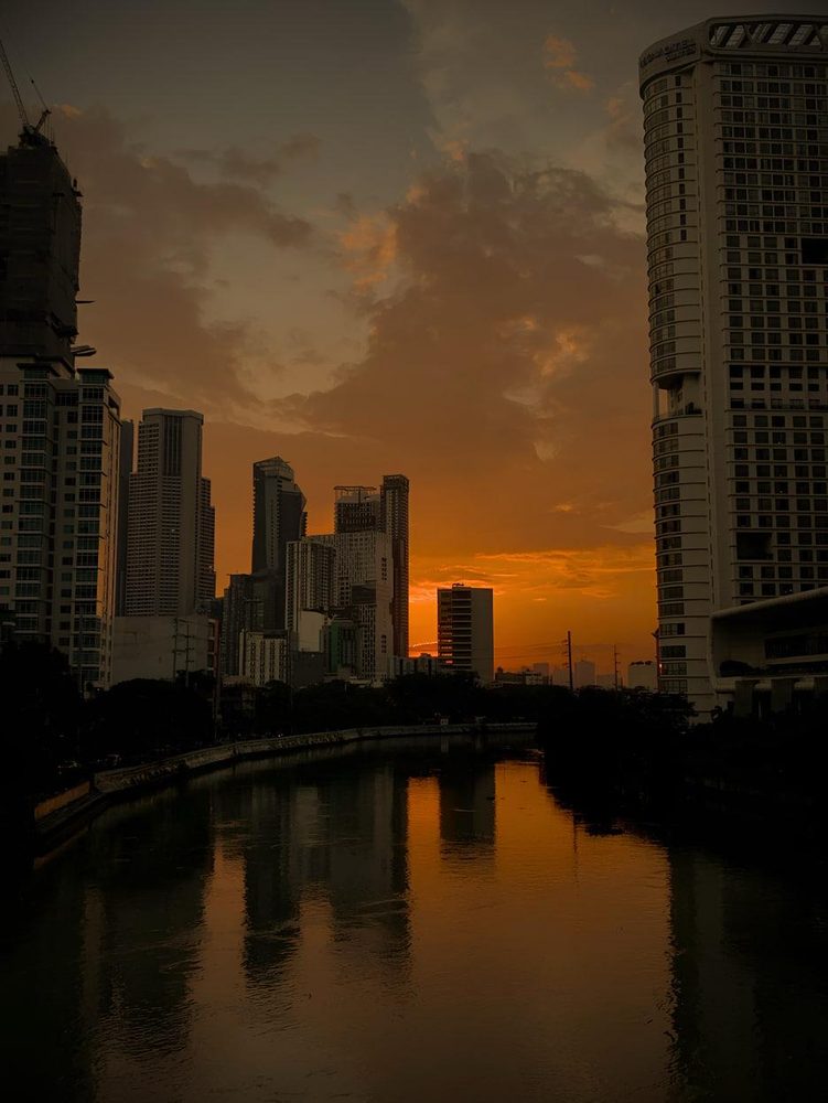 Sunset over the Makati skyline reflected in the Pasig River